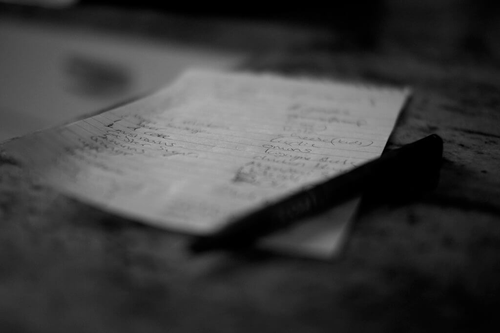 Black and white photo of paper and pen