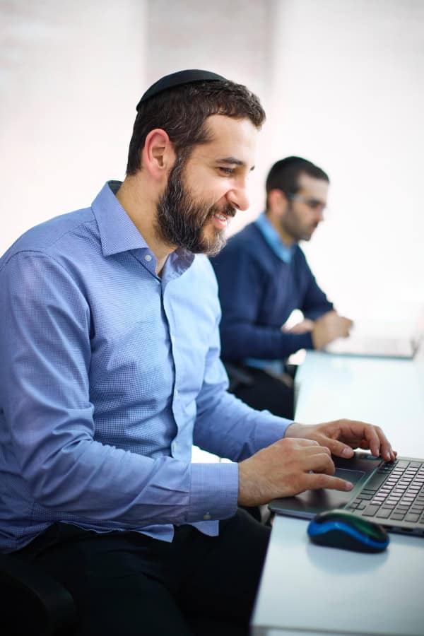 Joel working on laptop with Raph working in background
